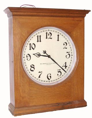 The American Clock Co., large battery powered wall clock, oak cased, with 18" dial, designed to run on two No. 6 dry cells, fitting in an alcove on top of the case, C.1905 — Antique Clocks Price Guide