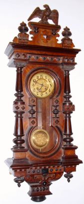 German, Spring Wall clock, with fancy keyhole door, 8-day with matched embossed dial center and pendulum, C.1890 — Antique Clocks Price Guide