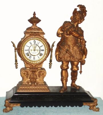 Ansonia Clock Co., PROVOCATION, cast metal figural clock on an enameled black iron base, 8-day, open escapement, premium movement with embossed plates. C.1890 — Antique Clocks Price Guide