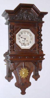 German, Mathias Bauerle, St. Georgen, Berlin style, FREE SWINGER wall clock in a dark fumed oak case with heavy barley twist columns on the door, and cast/gilt sunburst pendulum, QUARTER strike on 2 gongs, C.1890 — Antique Clocks Price Guide
