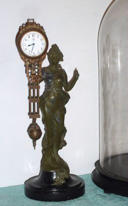 German, Junghans, small "Swinger" on Diana statue, and under a large round glass dome. C.1910 — Antique Clocks Price Guide