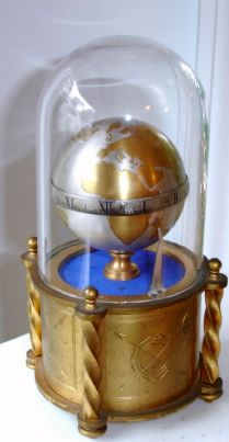 Swiss, miniature Globe Timepiece, with jeweled lever movement, and attached winder under base, with original glass dome, C. 1950 — Antique Clocks Price Guide