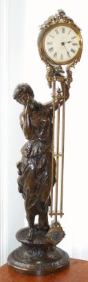 Ansonia Clock Co., New York, "JUNO" swinging arm clock, the arm moving without apparent impulse, the patinated spelter statue of the Goddess Juno, and the long canister style arm with original paper dial. — Antique Clocks Price Guide
