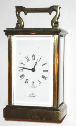 English, IMPERIAL, Brass cased carriage timepiece, in a simple Anglaise case, with unusual "tall" proportions, has attached knob for time set. C.1960 — Antique Clocks Price Guide