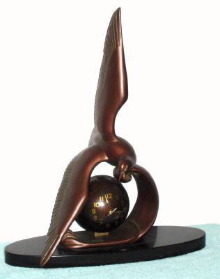French, Art Deco SEA GULL, figural clock, the well made platform lever, bell strike movement, contained within a bronzed brass ball, and with a sea gull in flight that is removable from the ocean wave for shipment. C.1935 — Antique Clocks Price Guide