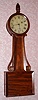 Unsigned Attleboro banjo clock, with carved mahogany side arms, 8-day, weight driven, C.1850.