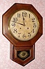 Ansonia Clock Co., short drop octagon wall clock, time and strike, 8-day, walnut veneer case. C. 1910.