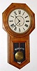 Waterbury Clock Co., CONSORT model, long drop octagon school clock, time only, in oak. C.1906.