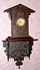 American, Primitive fret work clock and shelf, dark walnut, with an 8-day pendulum movement, time only. C. 1890.