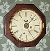Chauncey Jerome, New Haven, Conn, Octagon wall timepiece with alarm, in a well figured mahogany case, 1-day. C. 1860.