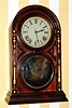 Atkins Clock Company, Bristol, Conn. Patented August 13th 1867, Victor Round Top No. 3, 8-day time and strike brass mvt in rosewood veneered case with gilded split columns on the sides and mirror tablet shelf clock, spring driven. C.1873.