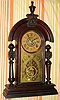 Ansonia Clock Co, Ansonia Conn. "KING" model, 8-day brass time and strike and alarm movement in black walnut case with carved lion topped tapered full round fluted columns, spring driven. C. 1880.