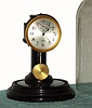 Poole Mfg Co., NY, "EXECUTIVE" model battery desk clock with molded plastic base and glass dome. C.1925.