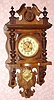 German, Junghans, Berlin style free swinger wall clock, walnut veneer, with matched embossed pendulum and dial center, 8-day time and gong strike. C.1905.