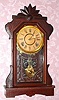 E. Ingraham and Co., PHENIX, walnut cased shelf clock, 8-day time and gong strike, spring. C.1881.