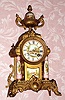 French, Samuel Marti, gilt metal with porcelain china accents, mantel clock, 8-day time and gong strike. C.1890.