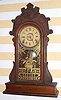 Geo. B. Owen, Winsted Conn, gingerbread mantel clock, 8 day time and strike on bell brass mvt in walnut case with 5" dial with center trim, spring driven. C. 1870.