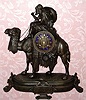 French figural white metal mantel clock, Arabic motif depicting Bedouin mounted on camel. Dial has applied gilt Roman numerals on blue enamel plaques and base has plaque with Arabic inscription, time and strike on bell 8 day spring driven mvt. C. 1870.