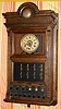 E. Ingraham and Co, Bristol, Conn, movement in a hotel burglar alarm clock with electrical components, spring driven time brass mvt with alarm function. Below dial are eight indicators covering zones or rooms in the alarm system and silent and battery test features in heavy walnut case with outer alarm bell set on top of case in crest. C. 1920.