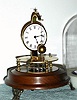 Horolovar Co., NY (Charles Terwilliger), repro of the famous Briggs rotary pendulum clock, 8-day, time, bottom wind, with glass dome. C.1975.