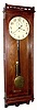 A probable Self-Wind full oak case with paneled sides, now with a large Seth Thomas weight movement that fits the original iron bracket perfectly. At first glance it looks similar to a No. 32, but that model has small columns the length of the case, and the door hinged inside, while this one is hinged at the outer edge, with molded door frame. C.1900.