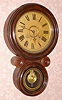 E. Ingraham and Co., "IONIC", figure 8 time and strike wall clock in a grained case. C.1911.