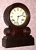 E. Ingraham and Co., "GRECIAN" round top shelf clock, 8-day time and strike, spring. C.1869.