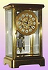 French, Marti and Cie, 4-glass "crystal regulator" in a Corniche case and with a porcelain dial with gilt overlay mask with floral center, and with 2 vial compensating pendulum. C.1900.