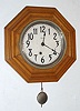 E. Ingraham and Co., 8-day, oak octagon wall timepiece, pendulum movement. Circa 1915.