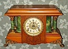Seth Thomas Adamantine, the SHASTA, an unusual finish with clear cello over cherry or maple, this offset by the look of green onyx sides and columns. We have not seen this color combination before, C.1905