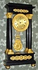 French, Empire style portico clock of black marble with finely chased ormolu trim and fancy grid pendulum, large movement (30-day ?) Retailed by a dealer in "New Yorck" C.1860