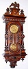 German, Spring Wall clock, with fancy keyhole door, 8-day with matched embossed dial center and pendulum, C.1890