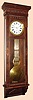 Waterbury Clock Co., "REGULATOR No. 7" walnut cased wall clock with glass on 3 sides, with pinwheel movement and center sweep seconds hand.