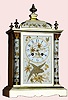 French, marked "Rack" and 'French make', a nickel finished bronze clock with aviary panels, time and strike, 8-day, serial 10030, and with matching number pendulum, "Paris" on dial, C.1895.