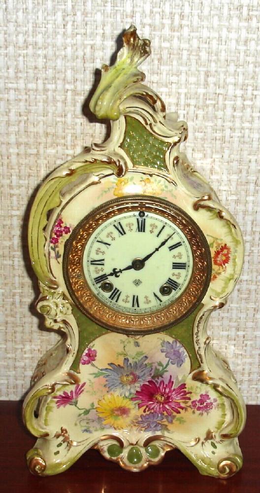 Ansonia Clock Co., C.1895, Royal Bonn, "LA CAPELLE" porcelain china cased clock, with 8-day, gong strike mov't, as-found. Colors are light yellow and muted green with bright floral accents and fancy dial. — Antique Clocks Price Guide
