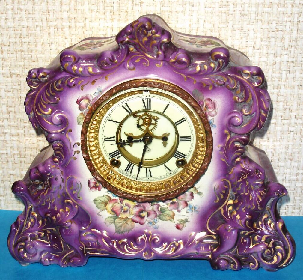 Ansonia Clock Co., C.1895, Standard Line, "REPORTER" porcelain china cased clock, with 8-day, gong strike mov't, with open escapement on the dial, in Violet. — Antique Clocks Price Guide
