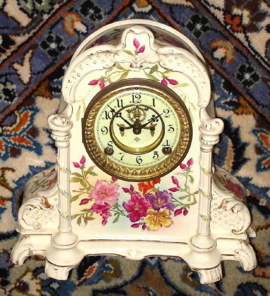 Ansonia Clock Co., Royal Bonn, "No. 500", porcelain clock in the French style, with open escapement on the dial center. interesting case style with garlands around the side columns. — Antique Clocks Price Guide