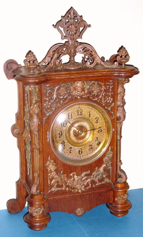 Ansonia Clock Co., "CABINET - B", oak cased clock with antique brass trimmings, 8-day gong strike mov't, and with embossed brass dial, c.1894 — Antique Clocks Price Guide