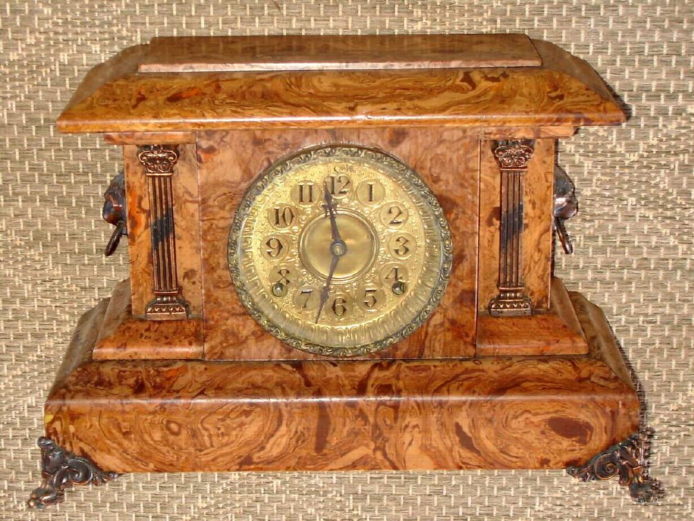 Seth Thomas Clock Co., Thomaston, Conn, C.1894 [dated] "ADAMANTINE" mantel clock with cello veneer in a light tan or walnut color, and with embossed brass dial. — Antique Clocks Price Guide