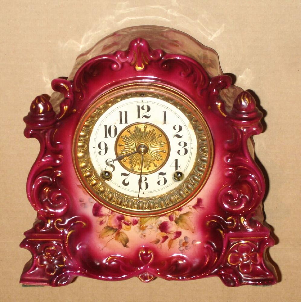Ansonia Clock Co., C.1910, Standard Line "TARGET" model porcelain china clock in dark violet and with cark violet pansy decorations. Paper dial with brass center. — Antique Clocks Price Guide