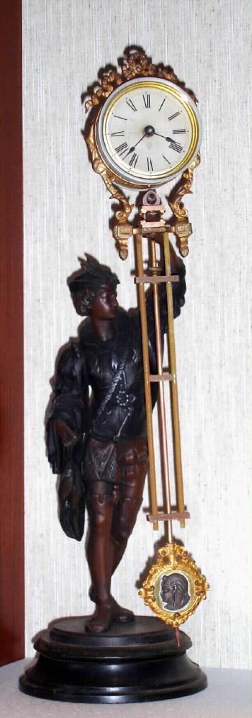 Ansonia Clock Co. New York, C.1880, "FISHER" canister swing clock (3" dial), on early shallow base. Note cast figure hold the clock arm aloft, and the entire arm swings without apparent impulse. — Antique Clocks Price Guide
