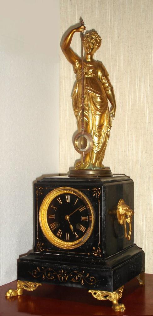 French, Guilmet patent, "MYSTERY" clock, the movement housed in a heavy marble base, and the statue standing on a well hidden carriage that is free to turn back and forth. An arm on the carriage extends into the movement. The pendulum pulls on the carriage in one direction, unlocking the escapement, and then the carriage is given a push in the opposite direction keeping the sequence going, c.1885 — Antique Clocks Price Guide