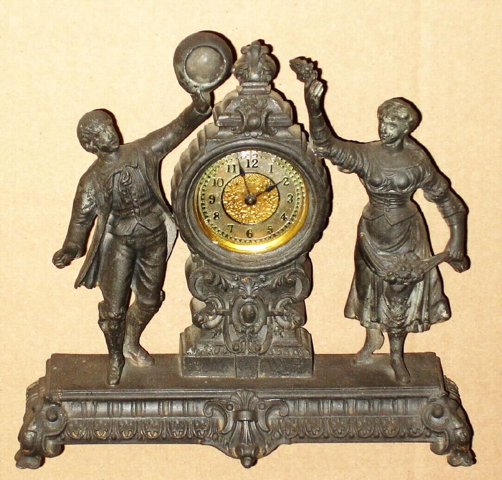 Ansonia Clock Co. New York, C.1896, "FROLIC", one day novelty, cast spelter, showing a farm couple dancing, mov't with silvered dial with embossed floral center. — Antique Clocks Price Guide