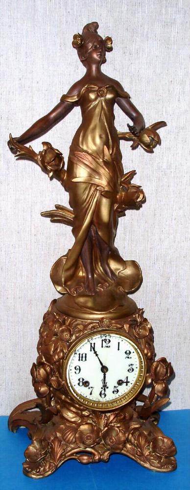 Ansonia Clock Co. New York, C.1904, "FLEUR DE LYS and 1175", Art Nouveau figure and base, 8-day strike with rococo sash and porcelain dial. — Antique Clocks Price Guide