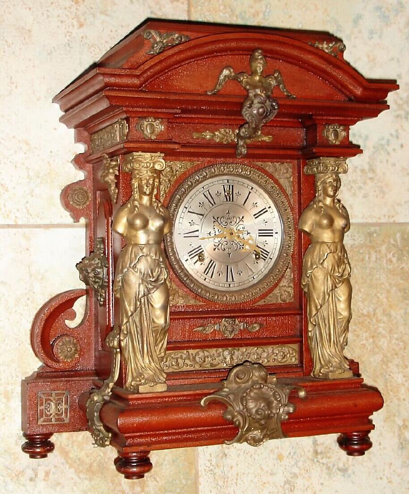 Ansonia Clock Co., New York, C.1894 "SENATOR", antique mahogany cased mantle clock with brass trimmings. Features full figured female columns on either side of the dial with other large and impressive brass bits. 8-day, time and gong striking. — Antique Clocks Price Guide