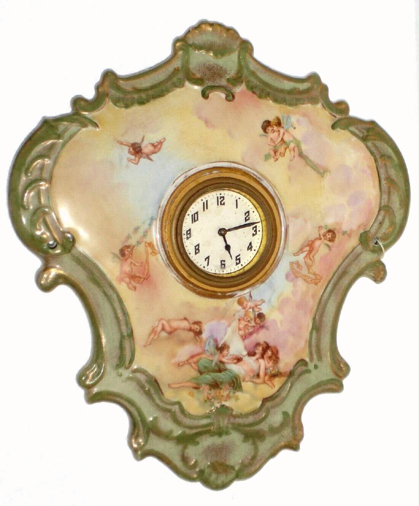 Ansonia Clock Co., C.1906, "PORCELAIN HANGING No. 4" china cased wall clock, depicting winged cherubs among the clouds. — Antique Clocks Price Guide