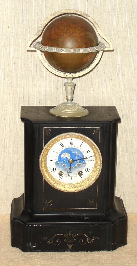C.1890, French, Edouard Serin, World Time Globe, striking, with phases of the moon and with the name of the retailer, Gowland, Sunderland on the porcelain dial. Uses a unique bell strike movement, with drive mechanism turning at a 90 degree angle from the rear plate and extending up to drive the globe at top. The globe is signed Edouard Serin. There are 24 small porcelain cartouche around the brass ring at the equator. — Antique Clocks Price Guide