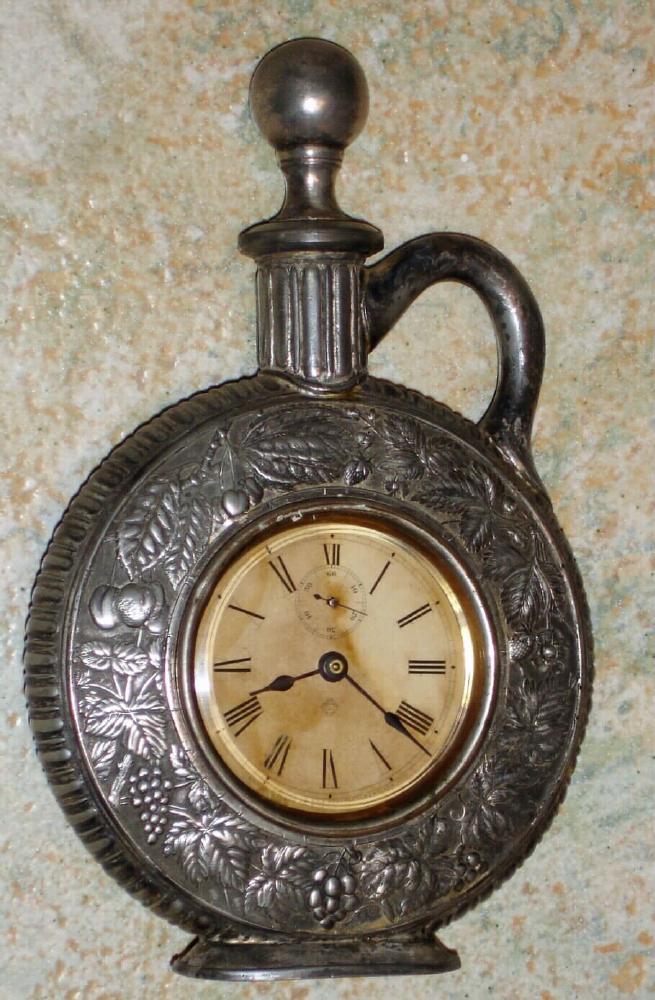 Ansonia Clock Co., New York, C.1900, "JUG" cast metal desk novelty in the shape of a pitcher or jug, with one day timepiece movement. — Antique Clocks Price Guide
