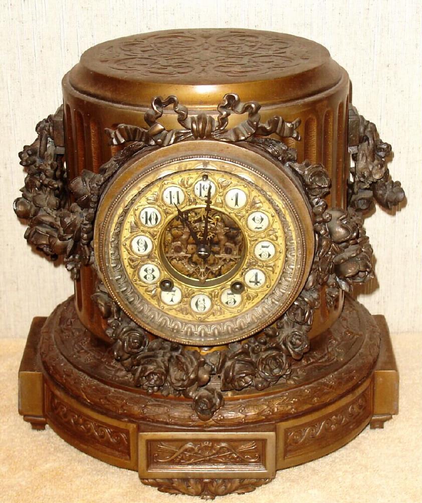 Ansonia Clock Co., New York, C.1904, "FLORIDA" base only, complete with movement, dial and gong. This base will accept Music, Cherubs, Gaiety, Art, Commerce, or any large Ansonia statue with round base. Has fancy dial with individual cartouche numerals; scape wheel support is 2 miniature brass cherubs. — Antique Clocks Price Guide
