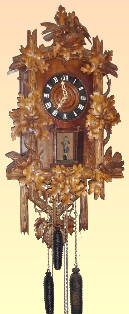 German, Emilian Wehrle, Furtwangen, 8-pipe wall hanging flute clock, time, gong strike and musical tune, 3-weight, chain driven case of carved oak leaves, and with nest of birds at top. — Antique Clocks Price Guide